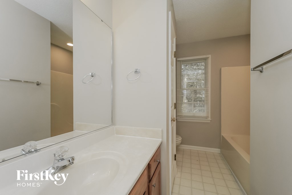 a bathroom with a sink and a shower and a toilet