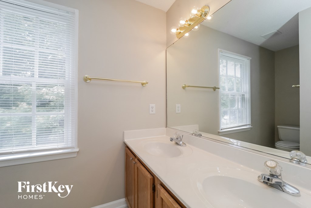a bathroom with a large mirror and a sink