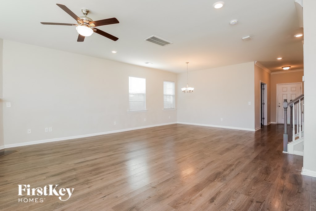 a living room with hardwood floors and a ceiling fan
