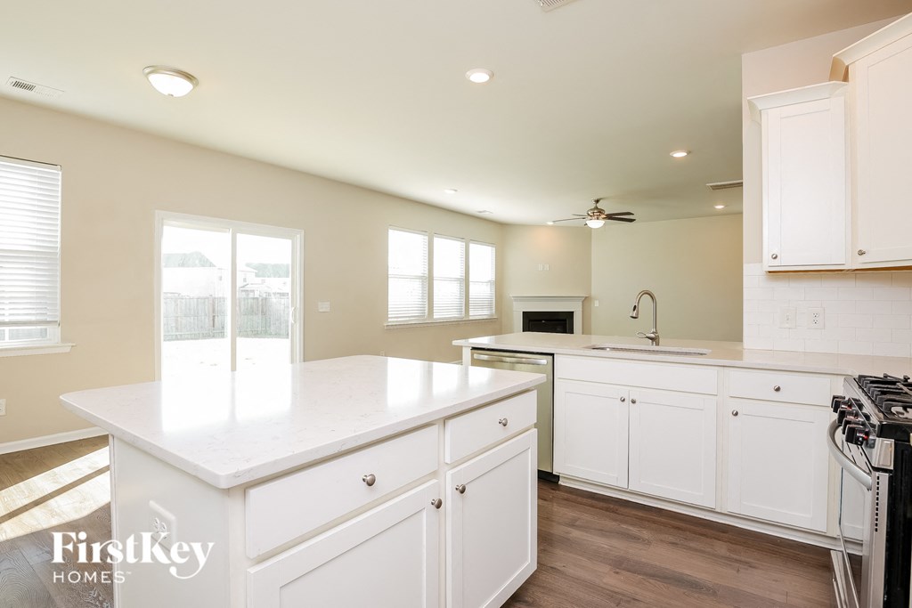 a kitchen with white cabinets and a white counter top