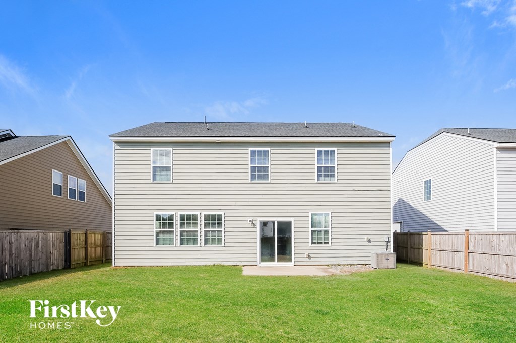 a white house with a yard in front of it