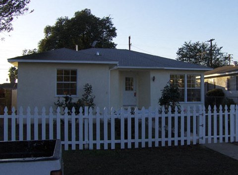 A white house with a white picket fence.