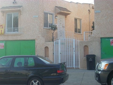 a black car parked in front of a building