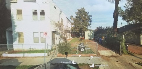 A white building with a no parking sign on the front.