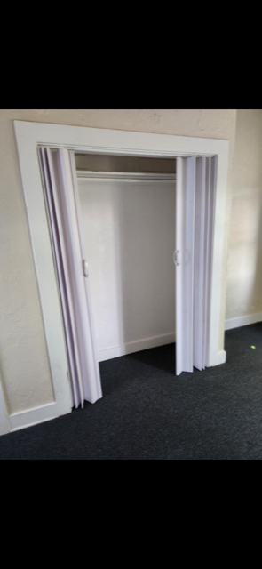A white door with a glass window is open.