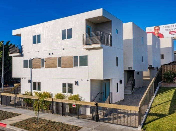 a white building with a fence in front of it