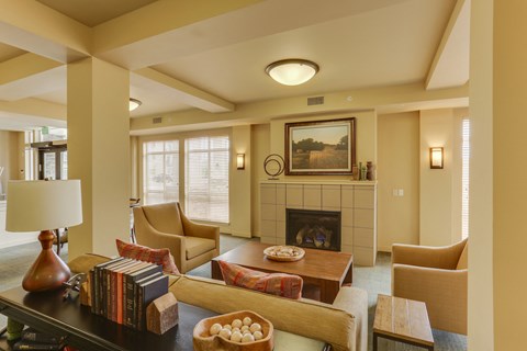A living room with a fireplace and a painting on the wall.
