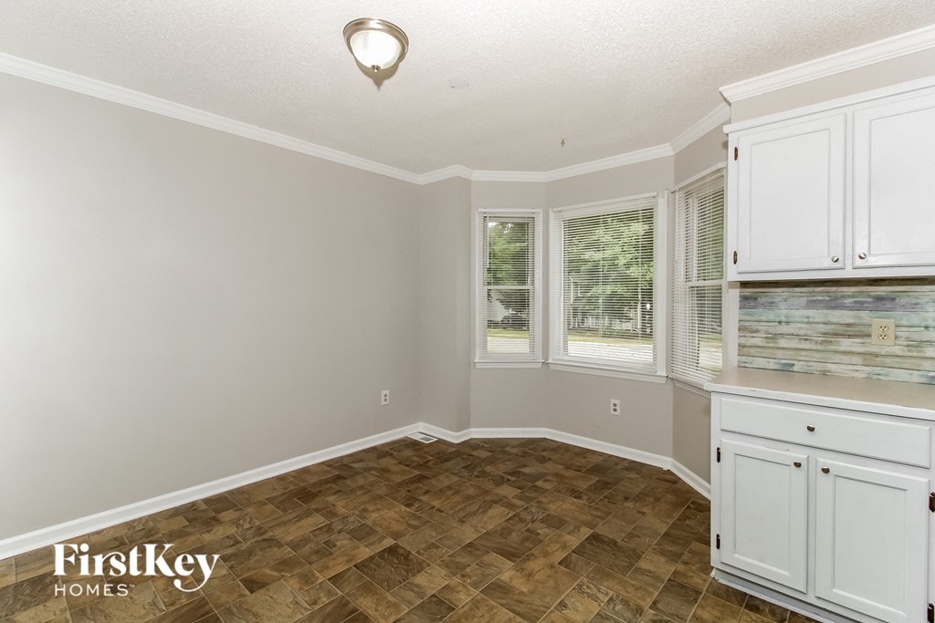 A room with a wooden floor and white walls.