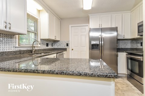 a kitchen with granite counter tops and stainless steel appliances