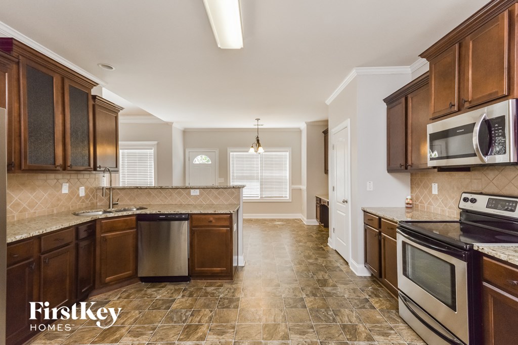 a kitchen with wooden cabinets and stainless steel appliances