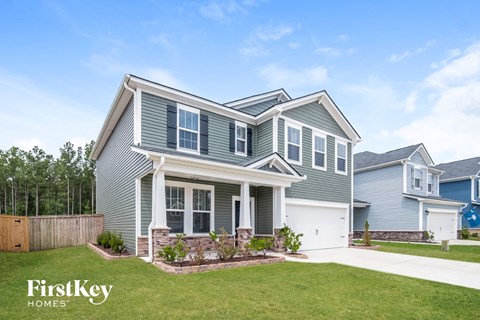 a house with blue siding and a lawn