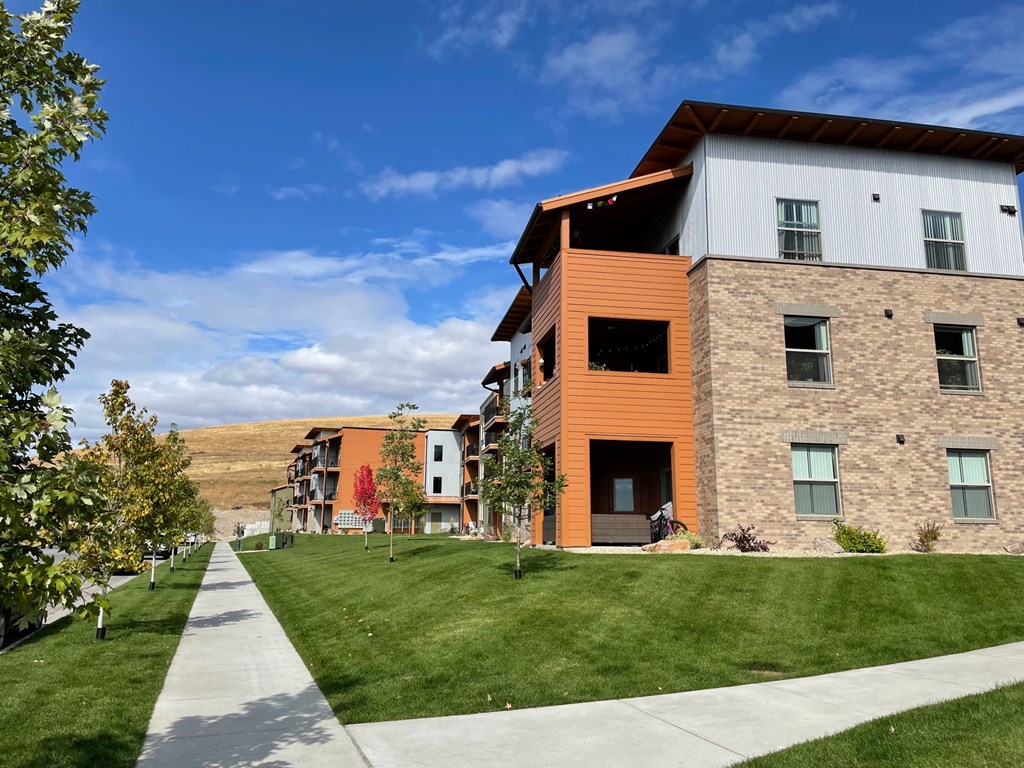 A modern building with a mix of stone and wood paneling.