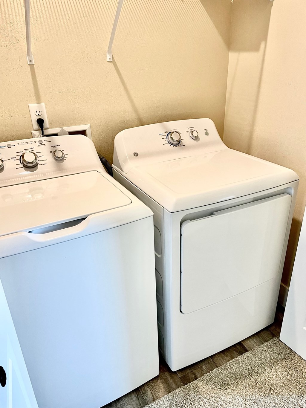 A white washing machine and dryer in a laundry room.