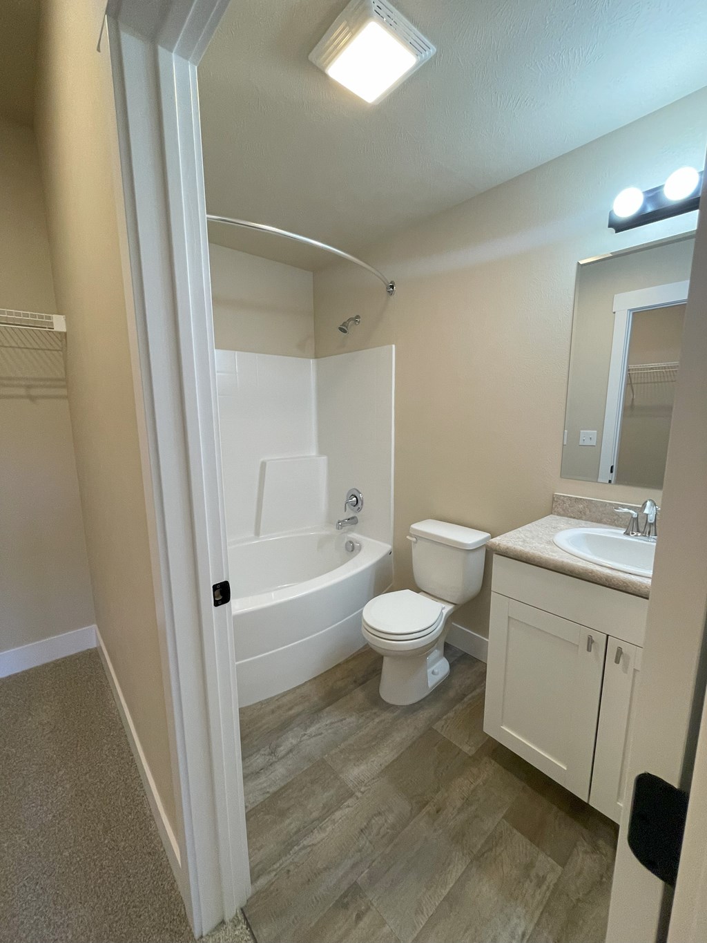 A bathroom with a toilet, sink, and bathtub.