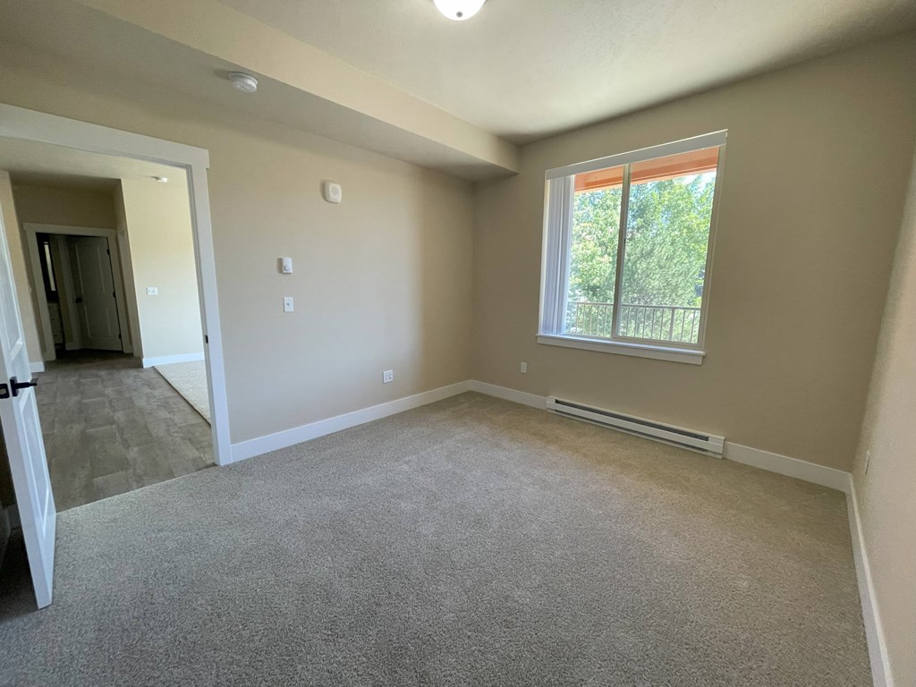 A room with a window and a door.