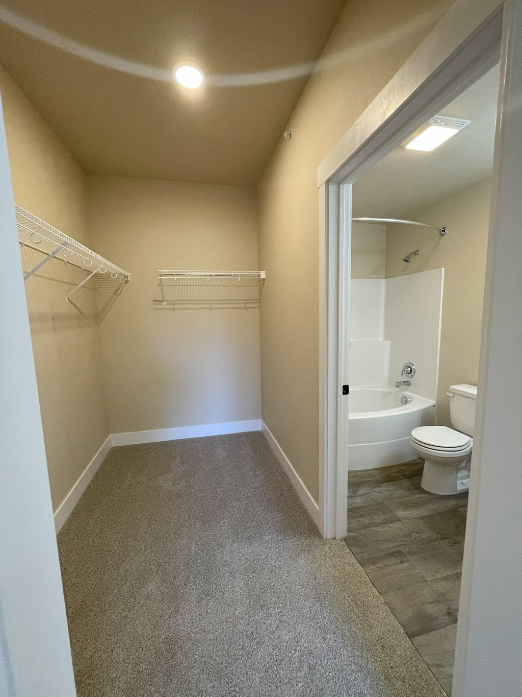 A small bathroom with a toilet and a bathtub.