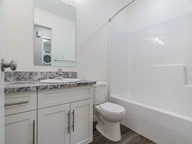 a bathroom with a toilet and a sink and a shower