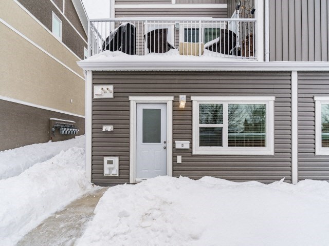 a small house with a white door in the snow