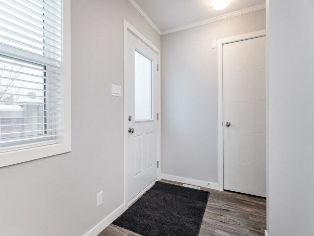 the entrance to a bedroom with a door and a window