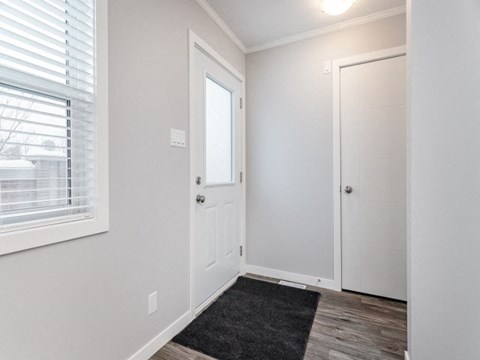 the entrance to a bedroom with a door and a window