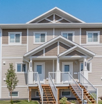 a white house with stairs and a