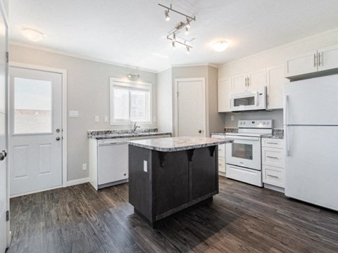 a kitchen with white appliances and a counter top