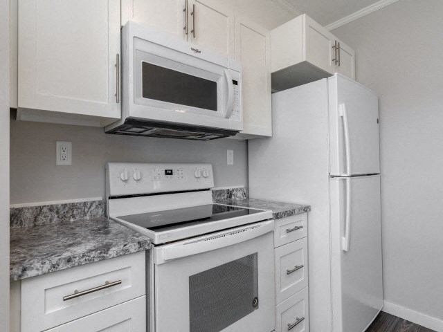 a kitchen with a stove microwave and refrigerator