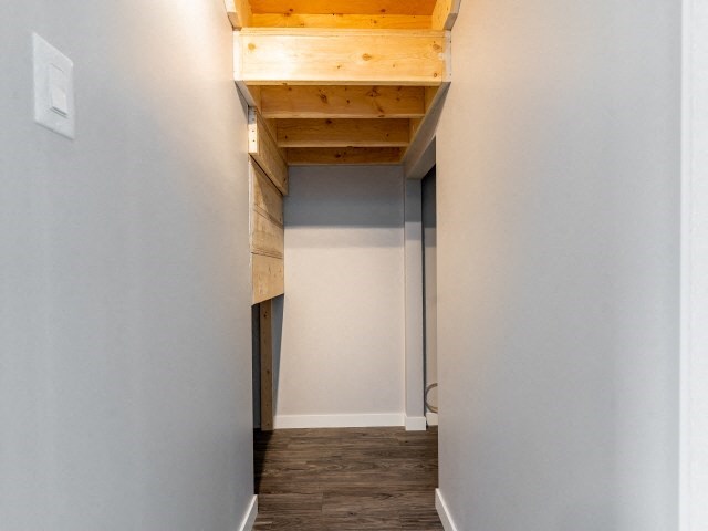 a empty room with a vaulted ceiling and white walls