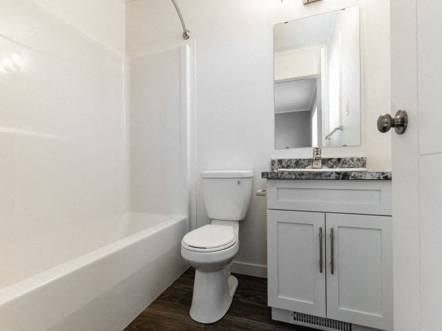 a bathroom with a toilet and a sink and a bath tub