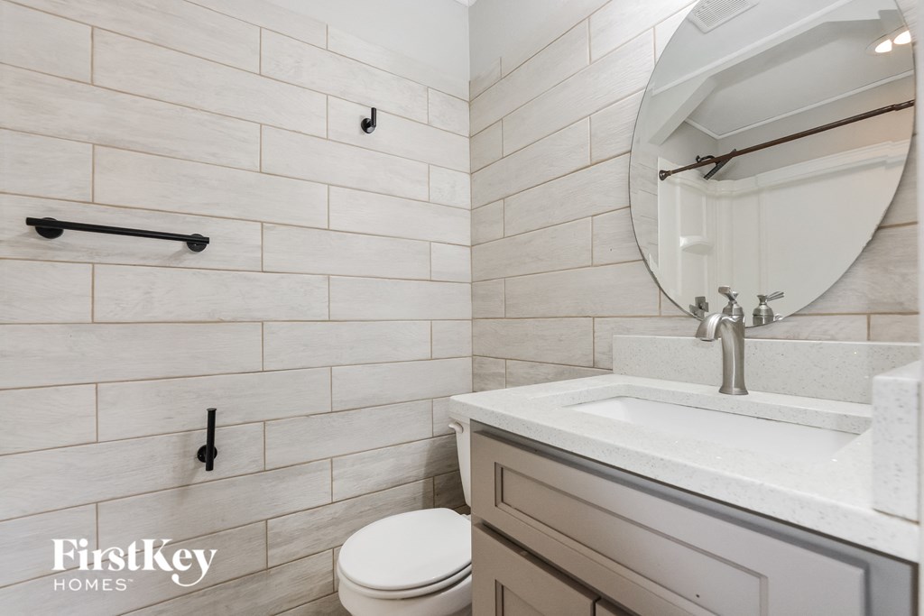 a bathroom with a sink and a toilet and a mirror