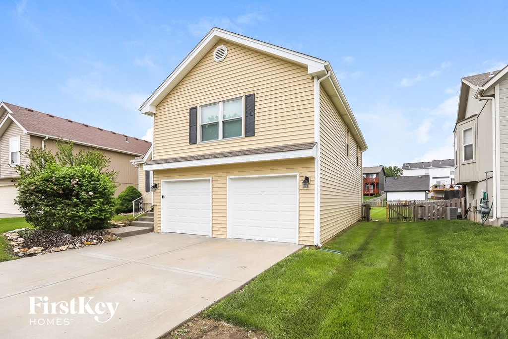 a yellow house with a white garage door