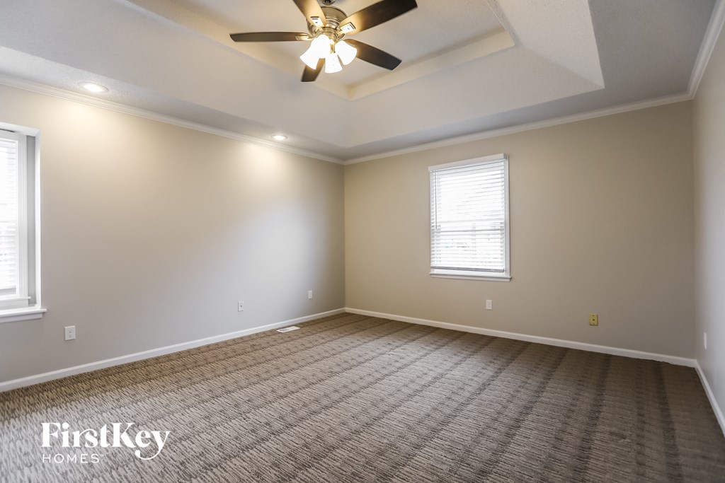 the living room of a new home with a ceiling fan