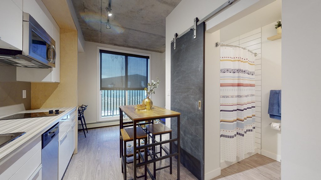 a kitchen and dining area with a table and chairs