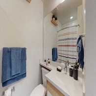 a bathroom with a toilet and a sink and a mirror