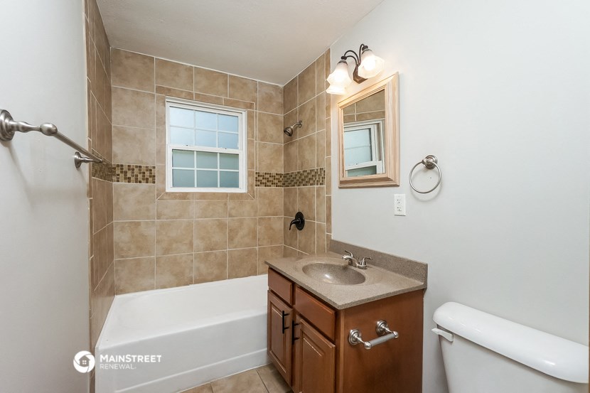 a bathroom with a sink and a shower and a bath tub