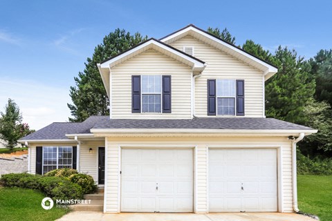 a white house with a garage with a white garage door