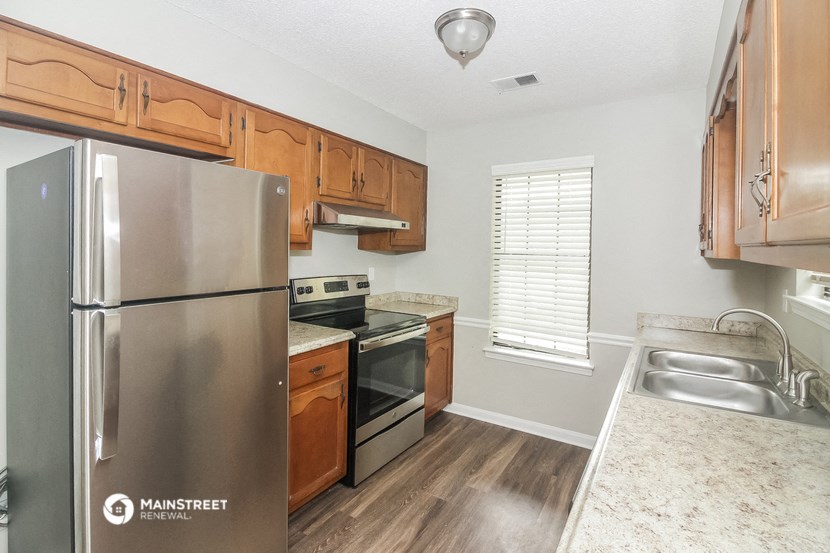 a kitchen with stainless steel appliances and wooden cabinets