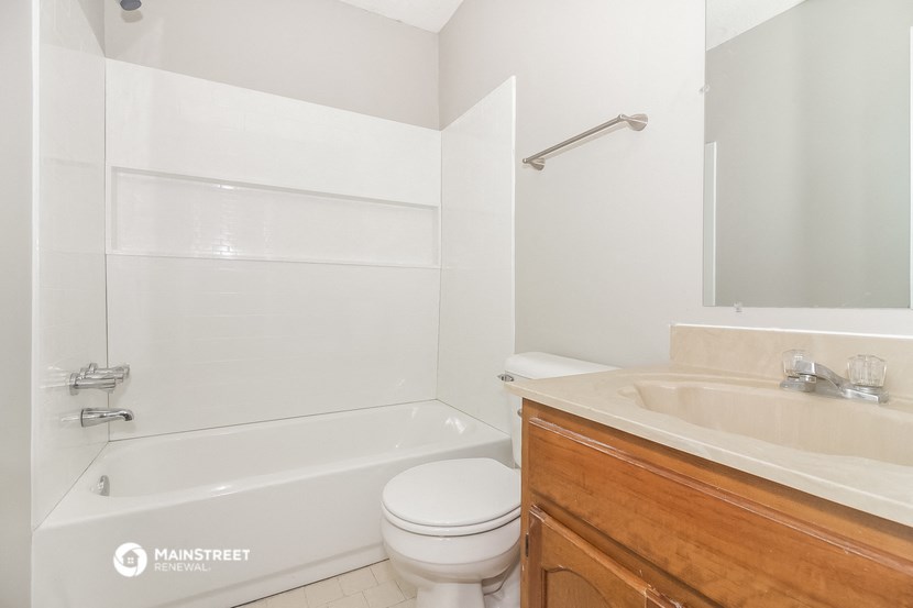 a bathroom with a toilet and a sink and a tub