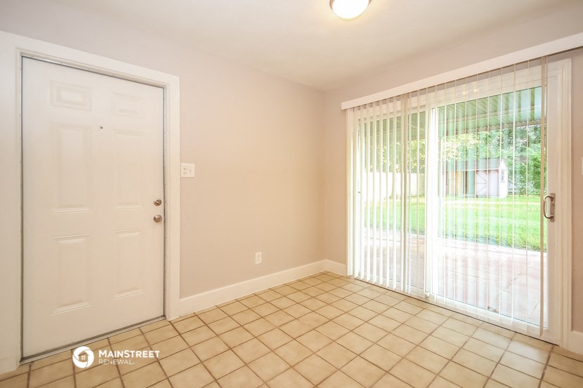 the living room of a house with a door to a yard