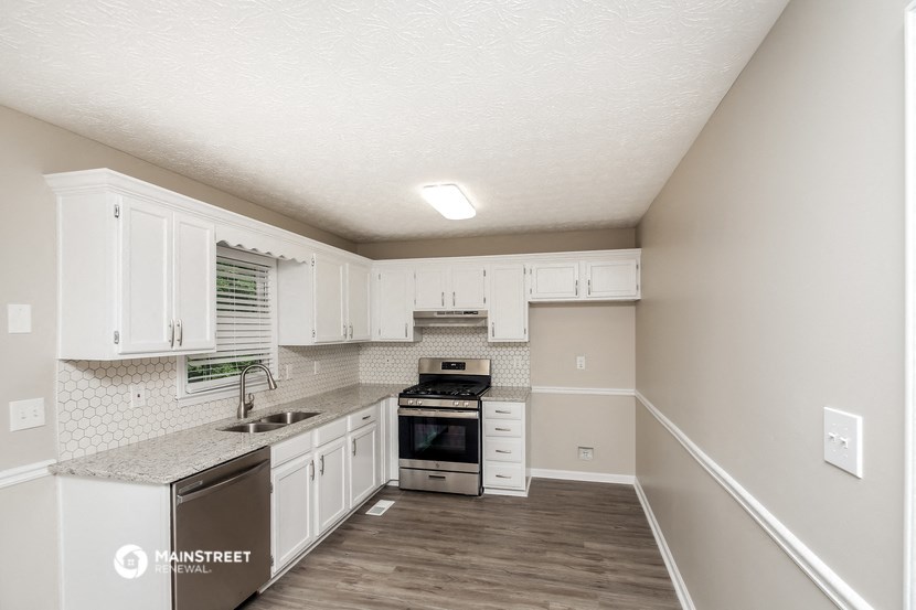the kitchen of our studio apartment atrium with white cabinets and stainless steel appliances