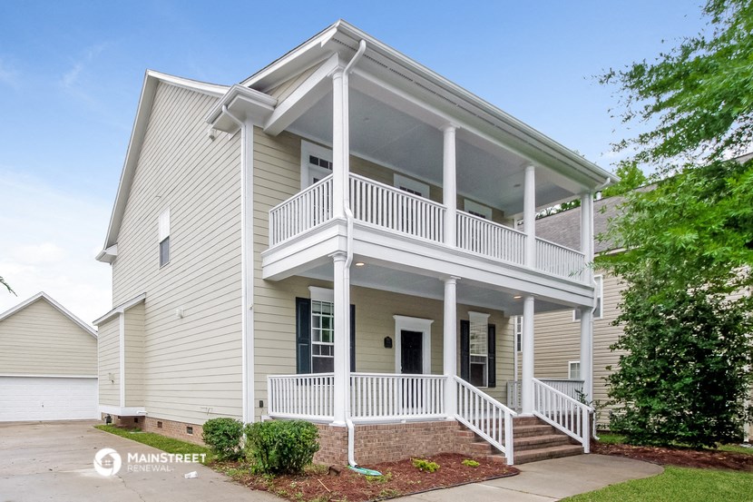 a white house with a white deck and a porch