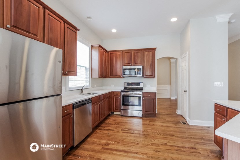 a kitchen with wooden cabinets and stainless steel appliances