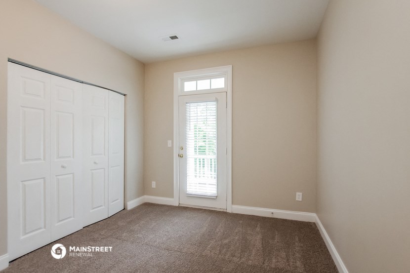 a empty room with a door and a window