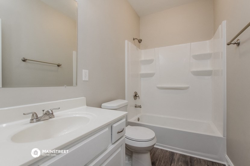 a bathroom with a sink toilet and a bath tub