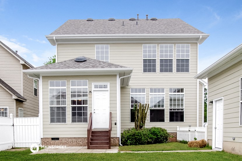 a white house with a white door and a lawn