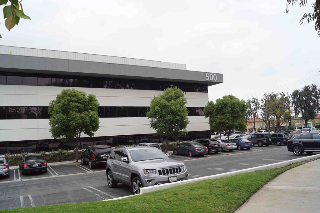 A parking lot in front of a building with the number 500 on it.