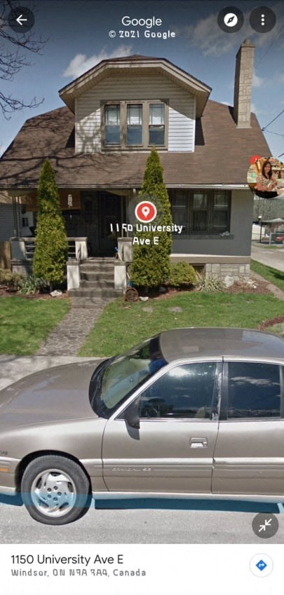 a silver car parked in front of a house