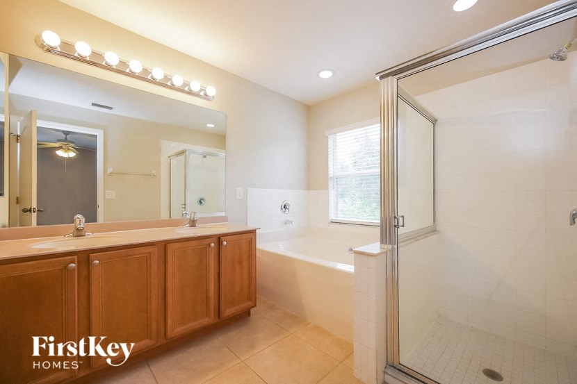 a bathroom with a sink and a shower and a tub