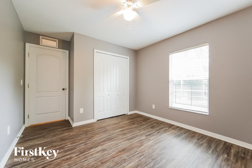an empty room with a white door and a window