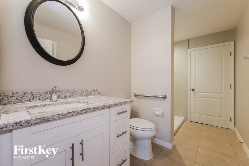a bathroom with a toilet and a sink and a mirror